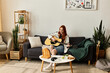© Bliss - Young woman enjoying her spare time while playing guitar in a cozy living room