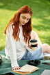 © Bliss - Enjoying a sunny afternoon with a book and coffee in a park