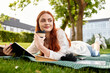 © Bliss - Relaxing in the park with a notebook and coffee during a sunny afternoon retreat