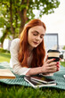 © Bliss - Relaxing outdoors with coffee on a sunny afternoon by the green park