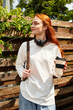 © Bliss - Young woman enjoys a sunny afternoon sipping coffee and relaxing outdoors with headphones