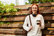 © Bliss - Young beautiful woman enjoying her spare time with coffee in a vibrant outdoor setting