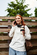 © Bliss - Young beautiful woman enjoying her spare time while chatting on the phone outdoors