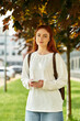 © Bliss - Young woman enjoying her spare time in a vibrant park on a sunny day