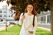 © Bliss - Young beautiful woman enjoying a sunny day outdoors while checking her phone in the park