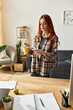 © Bliss - Young woman enjoying her spare time with coffee in a cozy modern living room