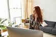 © Bliss - Young woman enjoying her spare time while sipping coffee and talking on the phone indoors