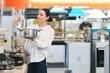 © Serhii - Pretty, young woman choosing a the right pot for her cooking in a modern home furnishings store