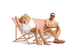 © Ljupco Smokovski - Young couple sunbathing in beach chairs