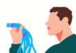 © Connect Images - Man holding a bundle of blue cables with a connector on a white background. Illustration