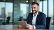 © Nathan - A smiling Caucasian man in a business suit, engaged with a tablet in a modern office setting.