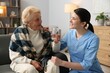 © New Africa - Nurse assisting senior woman indoors. Home health care service