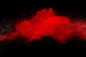 Wall Mural - red powder explosion on black background. colored cloud. colorful dust explode. paint holi
