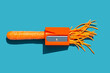© ADDICTIVE STOCK - Carrot pencil sharpener on bright blue background