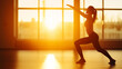 © Bonsales - Woman performs a lunge with arms overhead in warm side lighting of a minimal gym