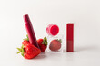 © ADDICTIVE STOCK - Elegant strawberry-themed cosmetic products on white