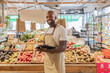 © ADDICTIVE STOCK - Eco store clerk with digital tablet