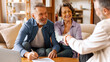 © Home-stock - Happy senior couple making financial insurance estate deal, satisfied customers shaking hands with broker, meeting bank manager agree on investment contract