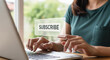© Inspire Shots Hub - Woman's hands interacting with a 'Subscribe' button on laptop screen, showcasing online subscription concept, simple and modern design, ideal for digital marketing