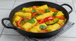© Wallace - Vibrant Pineapple Curry with Red and Green Peppers Served in a Black Cast Iron Skillet on a Gray Cloth, Garnished with Fresh Ci...