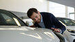 © Yuliia - Caucasian man buyer client auto automobile salon choose touching headlight car hood vehicle buying transport purchase test drive rent service smiling customer dealership guy male businessman dreaming