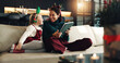 © peopleimages.com - Christmas, happy mom and kid with tablet in home for holiday, love and care. Xmas, parent and girl child with tech in living room for festive season, relax and family bonding together with daughter