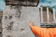 © EdNurg - Tourist pointing finger at inscription in ancient Greek that mentions the Roman Emperor Hadrian inscription carved on a marble stone in Pergamon