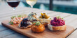 © sam richter - Elegant appetizer platter features gourmet spreads alongside wine glasses for sophisticated dining