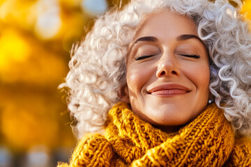 happy mature woman enjoying wonderful sunny day in nature , closed eyes, feeling nature