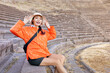 © EdNurg - Happy tourist visiting a historical amphitheater during summer holidays, exploring ancient architecture and enjoying the sunny weather