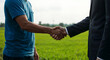 © MUHAMMAD - Handshake, Business Agreement Between Farmer and Businessman in Agricultural Field symbolizing a successful business agreement or partnership.  Agriculture Business partnership concept