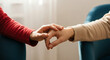 © ekhtiar - Two people holding hands showing comfort and support during a difficult time
