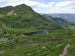 © Tomislav - Scenic Mountain Valley with Alpine Lake and Hiking Trail