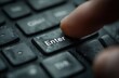 © andyaziz6 - Finger poised above an enter key on a dark keyboard, ready to submit data or execute a command.