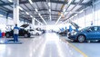© Rina - Blurry interior shot of cars being worked on in a spacious repair shop
