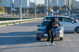 Caucasian man pulling a car with a rope. Caucasian man pulling a car with a rope.