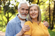 © New Africa - Lovely senior couple walking together in park