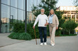 © New Africa - Lovely senior couple walking together near building outdoors