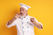 © New Africa - Professional pastry chef eating delicious dessert on orange background