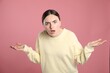 © New Africa - Portrait of shocked woman on pink background