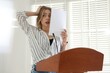 © New Africa - Fear of public speaking. Nervous woman with microphone at lectern indoors