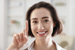 © New Africa - Happy woman with contact lens on her finger indoors