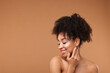 © New Africa - Portrait of beautiful Brazilian woman after spa treatment on light brown background. Space for text