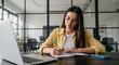 © MdMostafizur - Young woman with glasses is writing in a notebook at her desk