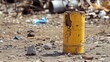 © Fauzerene - Bright Yellow Barrel Amidst Urban Waste and Debris in Industrial Area
