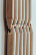 © num - Two groups brown crayons are placed sharp tips facing collide to each other stand in a neat row. Wooden pencils arranged in a symmetrical radial, The arrangement of the color pencils creates a sense.
