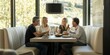 © phy - A modern breakfast nook with a family laughing and talking while having a meal