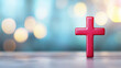 © nattapon98 - Red cross standing on reflective surface with soft blue and yellow bokeh lights creating peaceful spiritual atmosphere