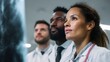 © Thares2020 - A team of doctors discussing an x ray image on a monitor in a diagnostics room