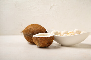 Wall Mural - Bowl with white chocolate candies and coconuts on light table